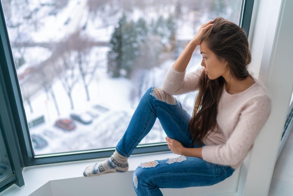 woman looking out window